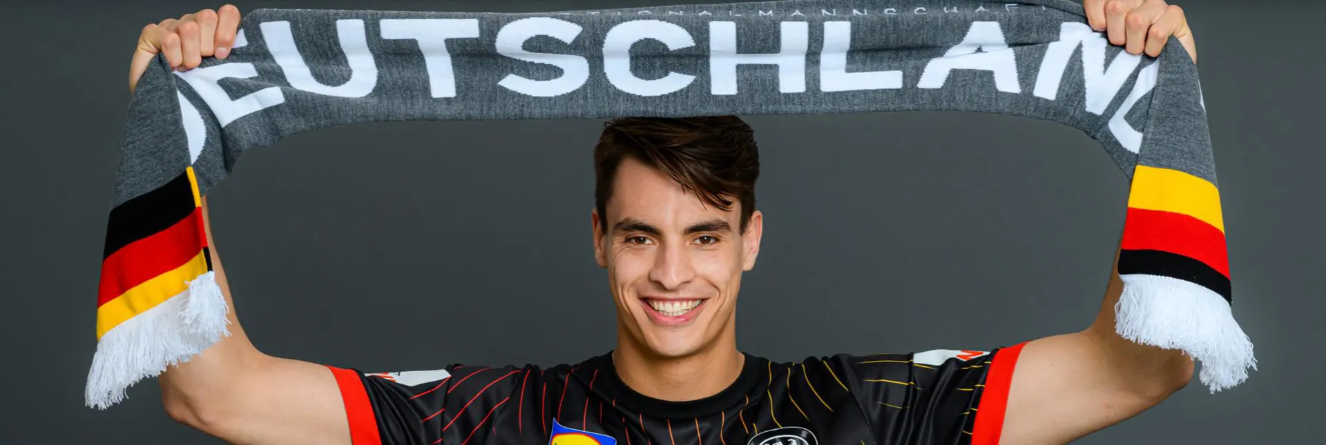 Julian Köster mit einem Fanschal